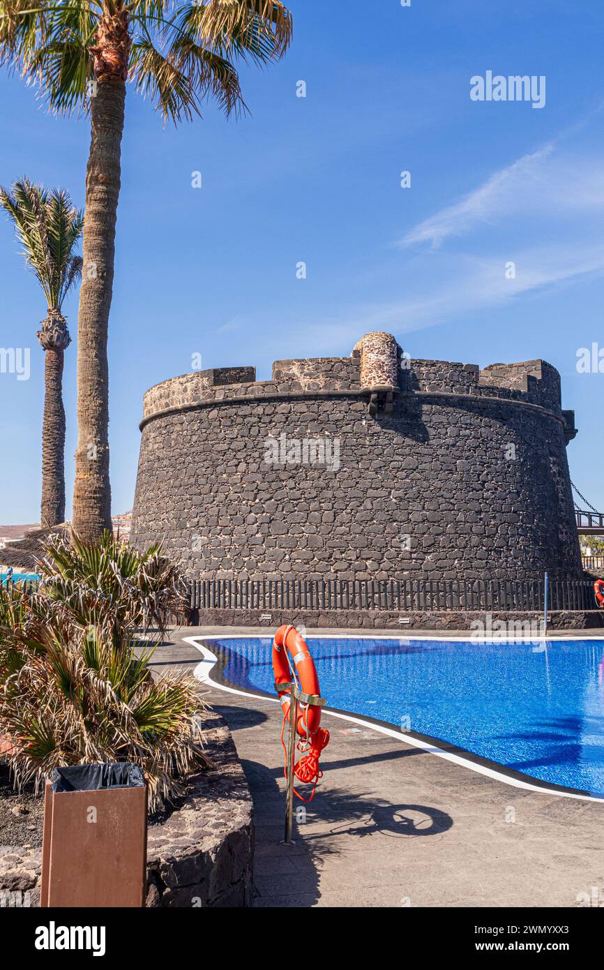 Der Verteidigungsturm Castillo de San Buenaventura aus dem 18. Jahrhundert neben dem Schwimmbad des Barcelo Fuerteventura Castillo Hotels in Caleta de Fuste Stockfoto
