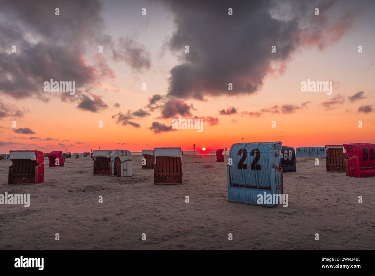 Korbliegen am Sandstrand von Neuharlingersiel bei Sonnenuntergang, Nordsee, Ostfriesland, Niedersachsen, Deutschland Stockfoto