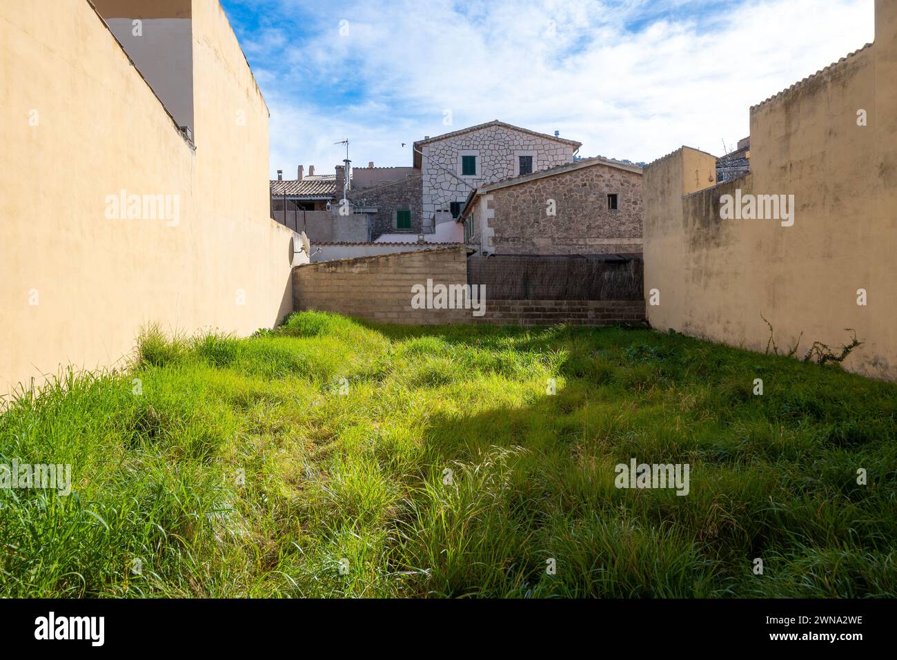 Valldemossa, Balearen, Spanien, Ein leeres Land mit Gräsern zwischen Häusern, nur Editorial. Stockfoto