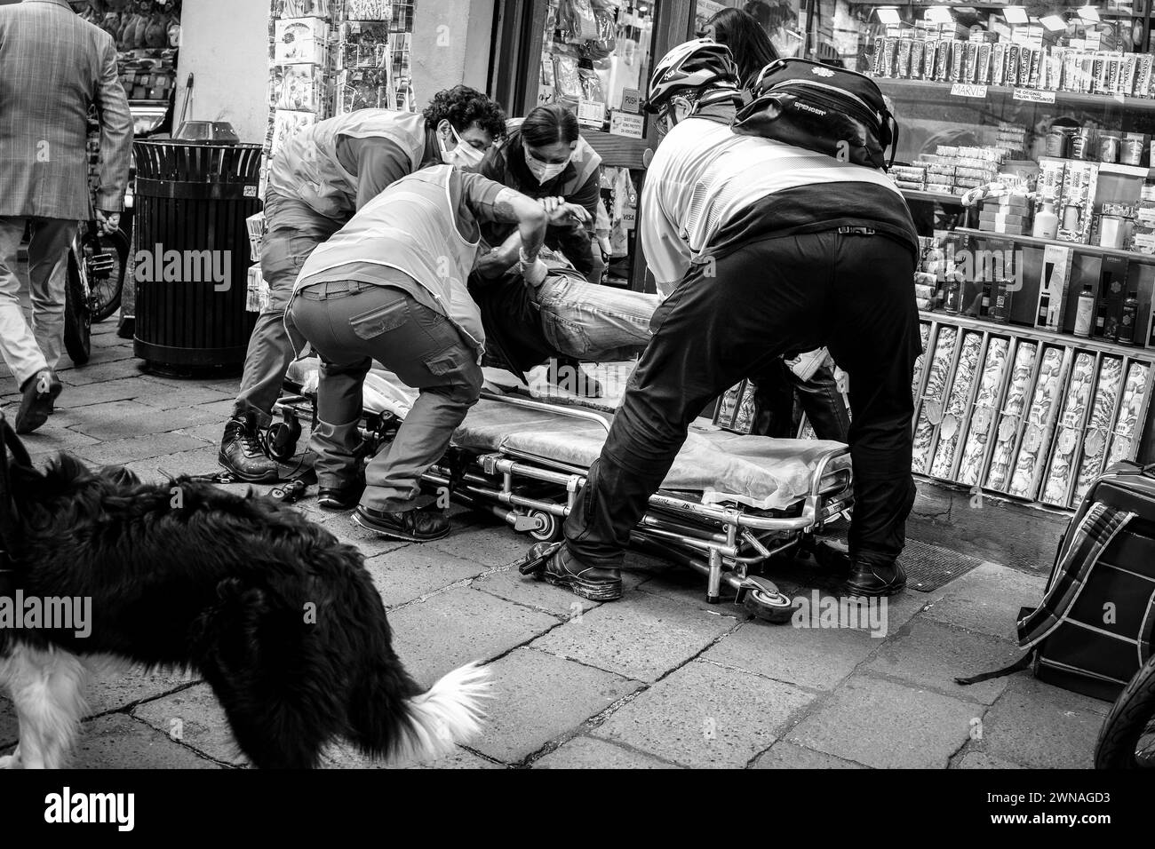 Eine düstere Streetfotografie-Reportage, die sich inmitten der Straßen der Stadt entfaltet und die Menschlichkeit und Widerstandsfähigkeit in Notfällen festhält - Schwarz und weiß Stockfoto