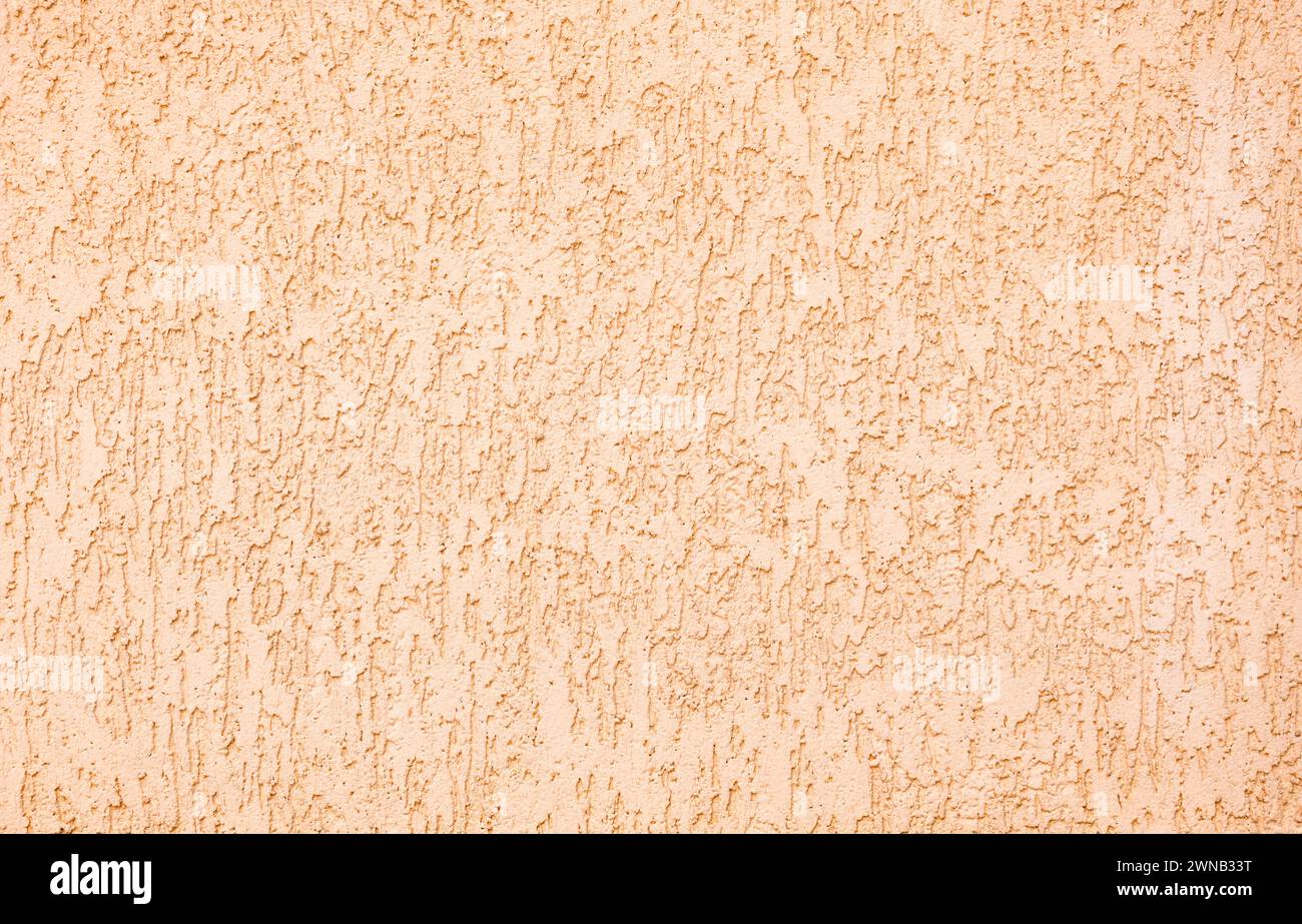 Textur von beigefarbenem Putz Gebäude Beschichtung Hintergrund. Willkürliches Muster. Stockfoto