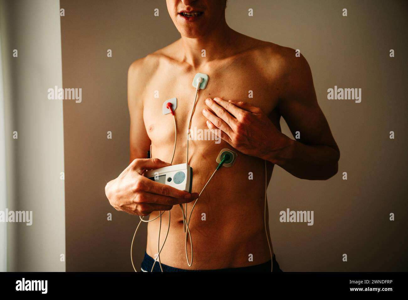 Herzfrequenzmesser. EKG-Aufzeichnung des jungen Mannes bei natürlicher Beleuchtung. Kardiovaskuläre Gesundheit für eine umfassende und aufschlussreiche Beurteilung Stockfoto