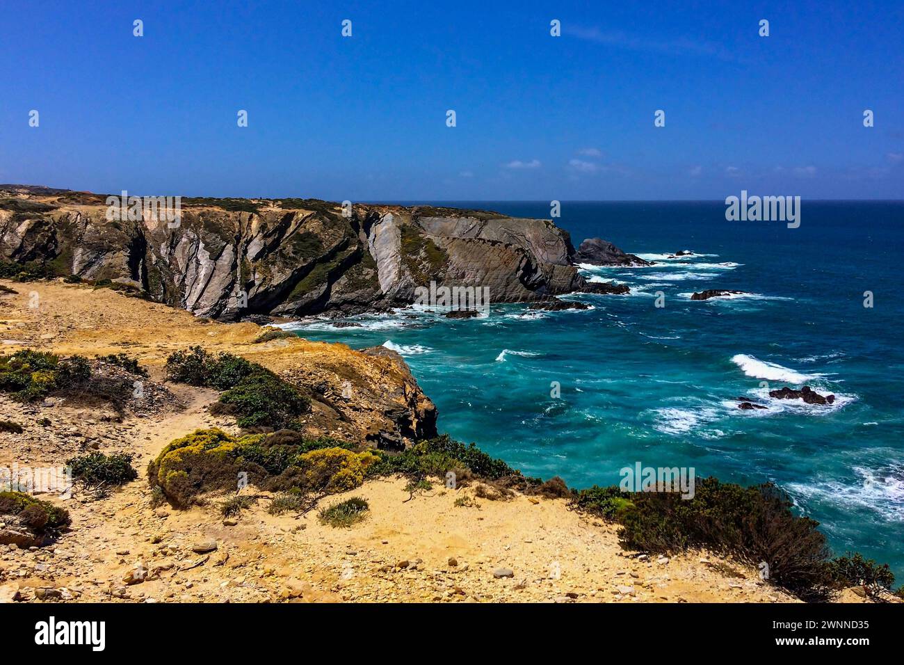 Klarer Himmel über turbulenten Meeren und zerklüfteten Klippen. Stockfoto