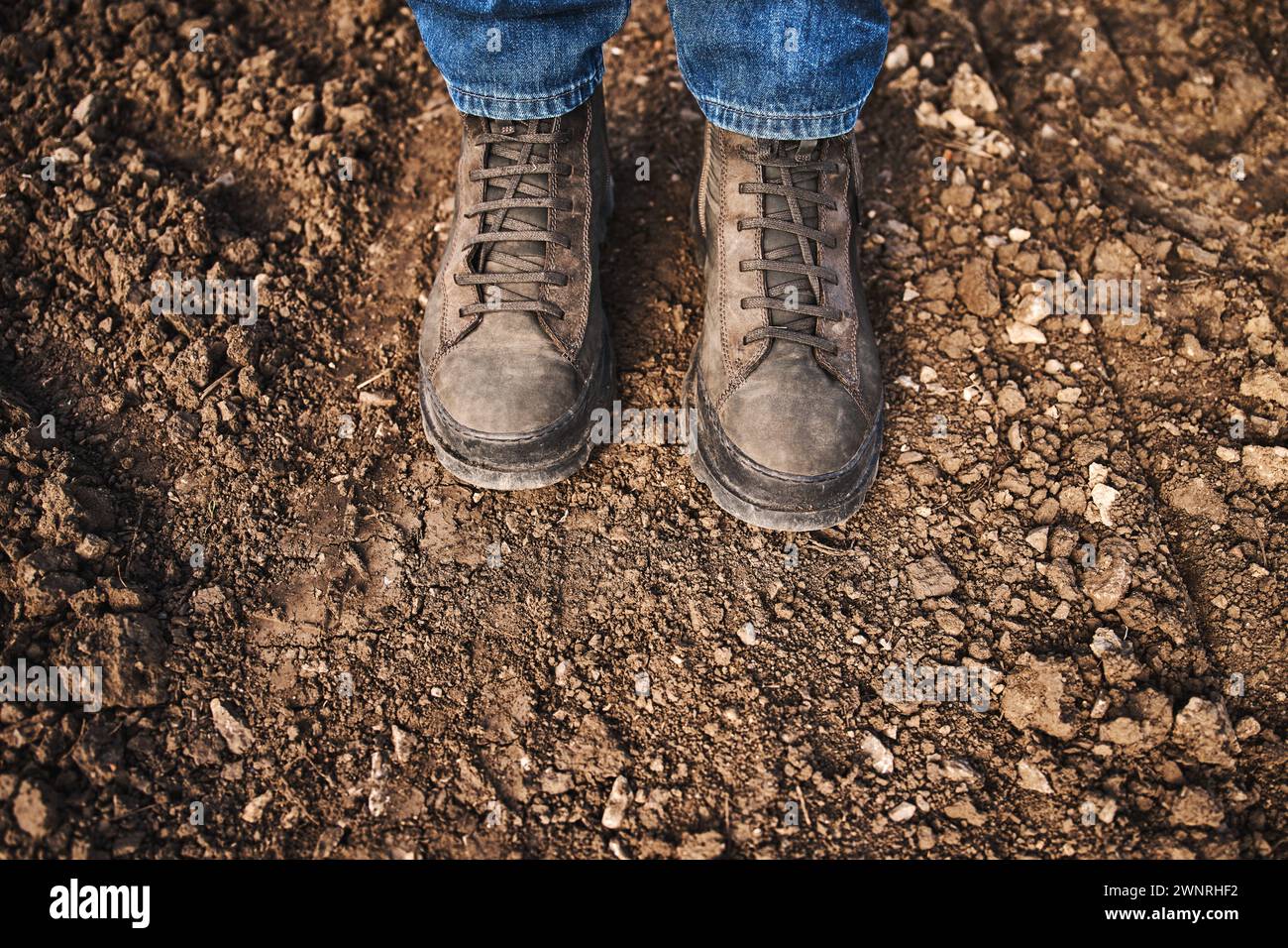 Schmutzige Stiefel auf Feldwegen, Bauer auf dem Land, selektiver Fokus Stockfoto