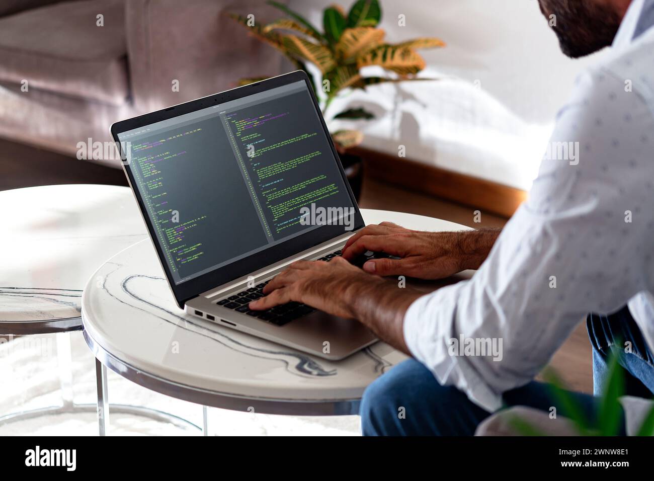 Programmierer, der HTML-javascript-Code in einen Laptop schreibt. Stockfoto