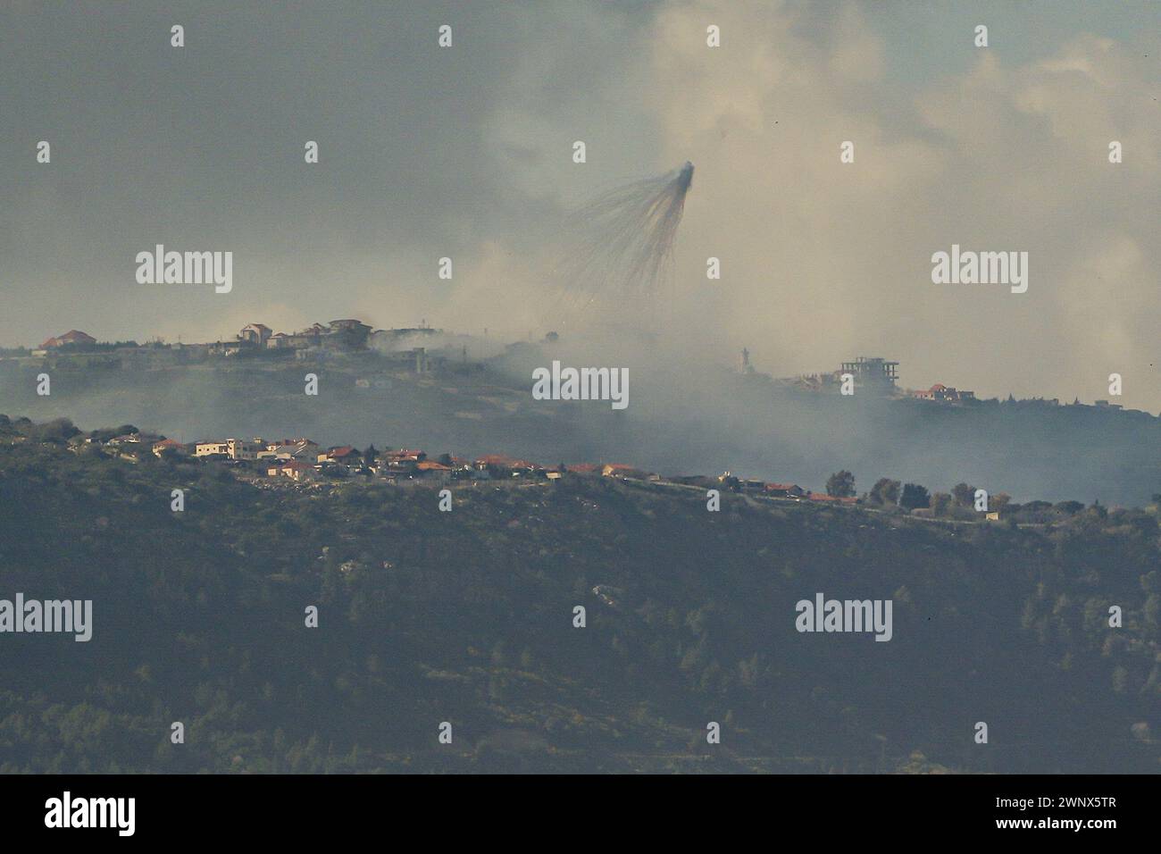 (240304) -- GRENZE ZWISCHEN ISRAEL und LIBANON, 4. März 2024 (Xinhua) -- Rauch steigt aus dem libanesischen Dorf Markaba als Folge der israelischen Bombardierung am 4. März 2024 im Südlibanon neben der Grenze zu Israel auf. Ein indischer Staatsangehöriger wurde am Montag im Norden Israels durch einen Raketenabwehrangriff der Hisbollah im Libanon getötet und sieben weitere verletzt, sagten israelische Quellen. Die israelische Armee reagierte, indem sie Panzer- und Artilleriefeuer auf die Quelle des Raketenangriffs feuerte, so ein israelischer Militärsprecher. (Ayal Margolin/JINI über Xinhua) Stockfoto
