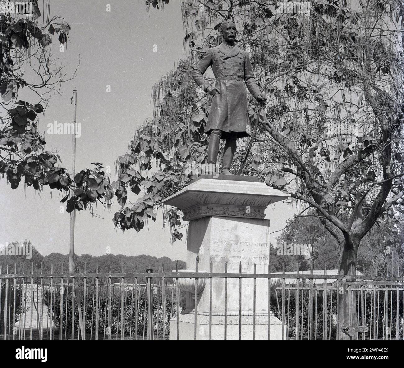 1930er Jahre, historisch, Quetta, Britisch-Indien und die Statue von Sir Hugh Shakespear Barnes, K. C. S. I K. C. V. O. Chief Commissioner und wie die Inschrift sagt... ein Gentleman des Generalgouverneurs in Baluchistan 1898–1900. Das Denkmal stand früher vor der Sandamen-Bibliothek, aber dieses Gebäude wurde 1935 bei einem Erdbeben zerstört. Shakespear Barnes war ein englischer Administrator im britischen Kolonialindien. Die Region Baluchistan, die zu dieser Zeit eine Provinz des Generalkommissars enthielt, würde später zusammen mit einer Reihe anderer staaten Teil Pakistans werden. Stockfoto