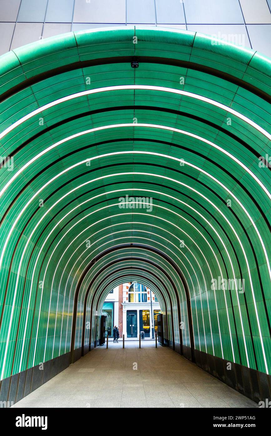 Tunnel durch ein Gebäude am Rathbone Square, glasierte Keramikfliesen und ein Messingtor, entworfen vom Künstler Robert Orchardson, Tottenham Court Road, London Stockfoto