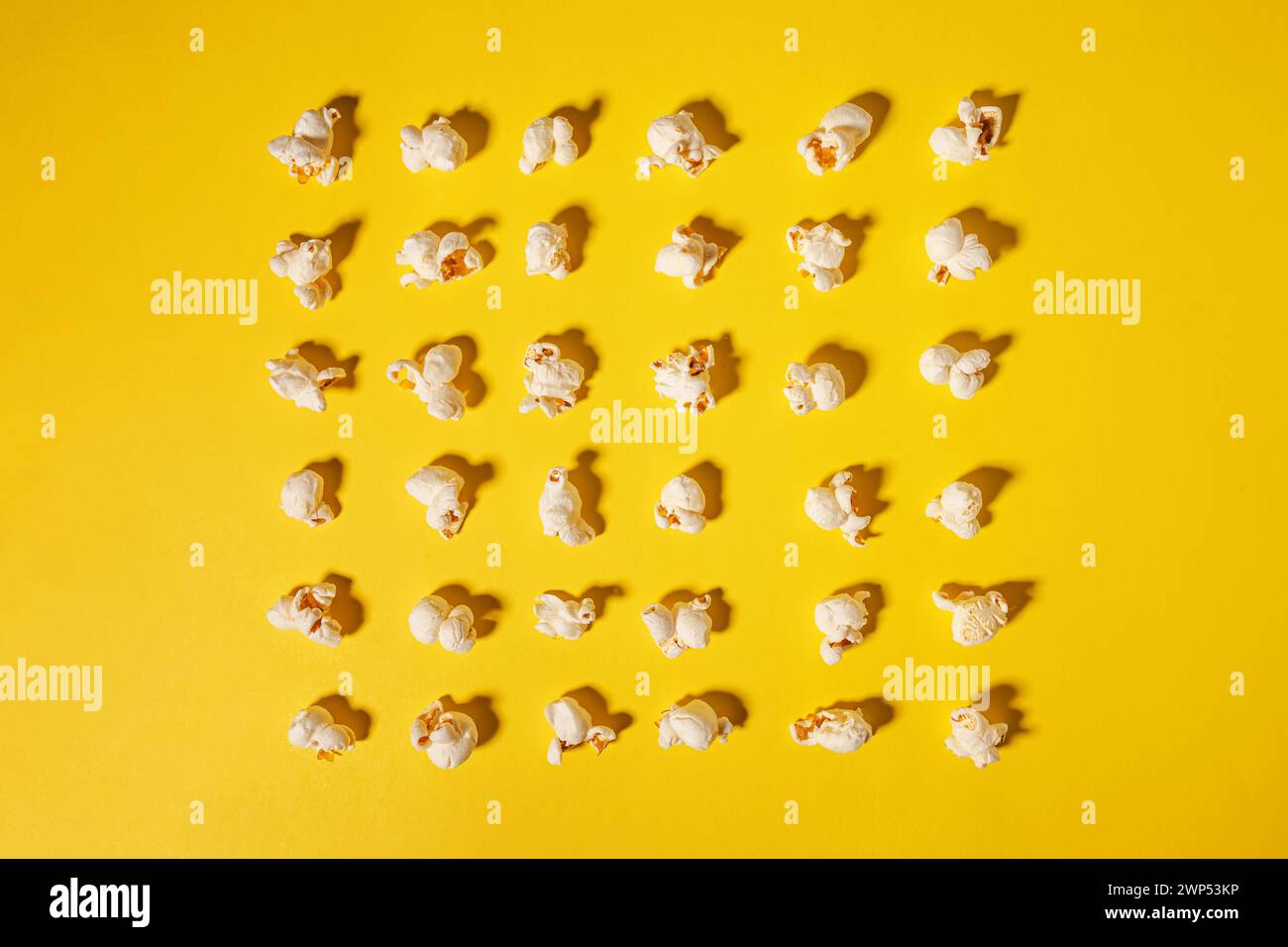 Popcorn isoliert auf hellgelbem Hintergrund, Filmabend Stockfoto
