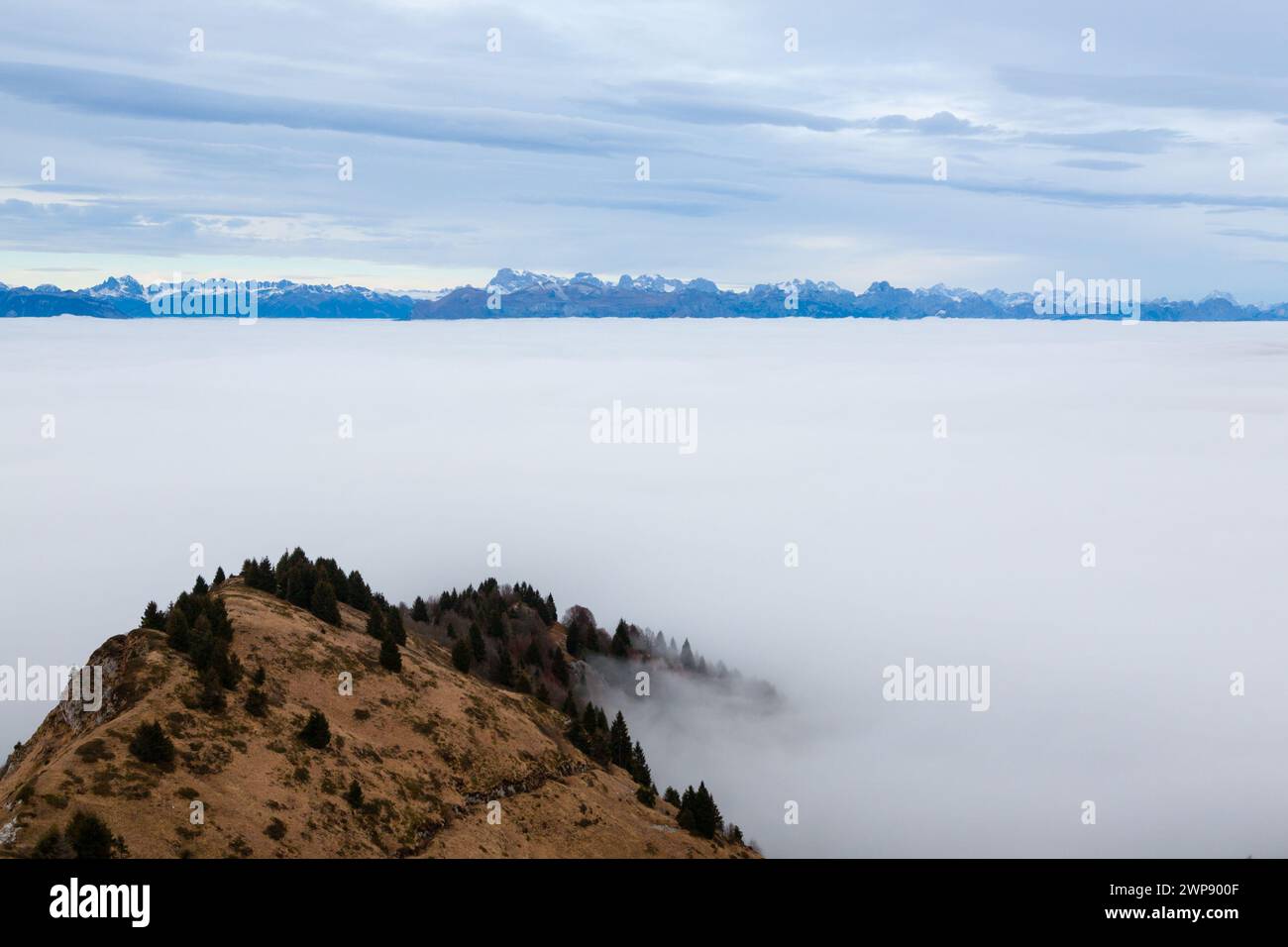 Ein Blick aus der Vogelperspektive auf den Berg Grappa im Wolkenmeer. Italienische alpen Stockfoto