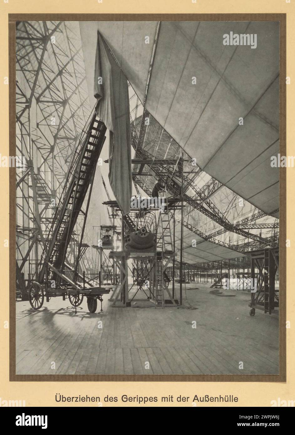 Anbringen der äußeren Abdeckung am Rumpf. LZ 127 Graf Zeppelin (Deutsches Luftschiff Zeppelin 127) war ein mit Wasserstoff gefülltes Luftschiff, das von 1928 bis 1937 mit der Baunummer LZ 127 (117. Zeppelin-Luftschiff) flog. Eigentümer: Luftschiffbau Zeppelin Q.m.b.H., Friedrichshafen a. B. Verwendung: LZ 127 soll die technische und wirtschaftliche Möglichkeit des transozeanischen Luftschiffverkehrs auf langen Strecken demonstrieren.Sammlung einschlägiger Erfahrungen, insbesondere der Erforschung der meteorologischen Bedingungen auf zukünftigen Transportwegen. Ausflüge für wissenschaftliche und vermessende pu Stockfoto