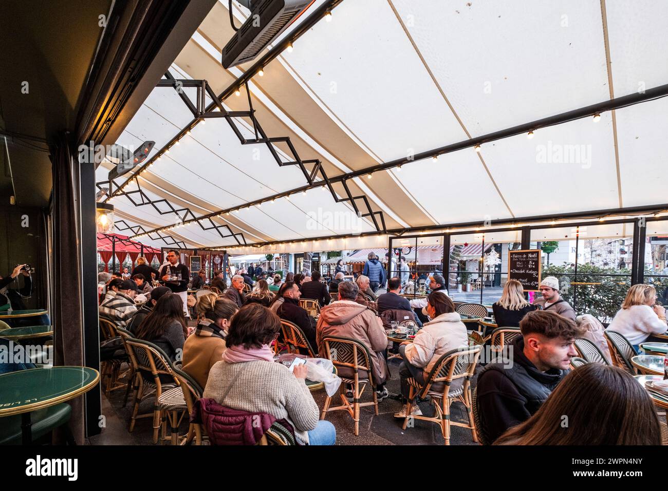 Menschen, die in einem Café in Nizza sitzen, Nizza im Winter, Südfrankreich, Cote d'Azur, Frankreich, Europa Stockfoto