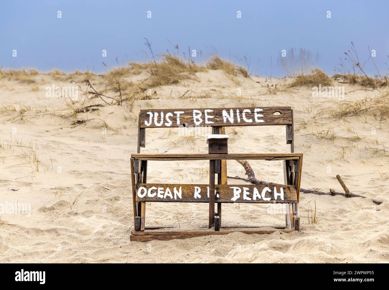 Eine krude Bank am Ocean Road Beach mit der Nachricht, dass man nett sein soll Stockfoto
