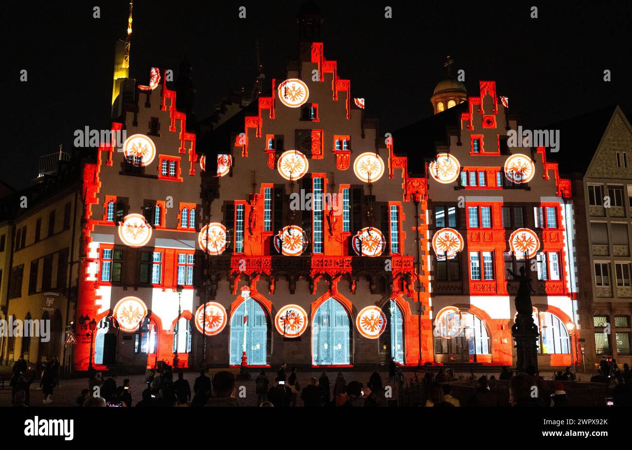 09. März 2024, Hessen, Frankfurt/Main: Eine Videoinstallation an der Fassade des Römers in Frankfurt erinnert an das 125-jährige Bestehen von Eintracht Frankfurt. Er zeigt zahlreiche Momente aus der Geschichte des Clubs. Foto: Boris Roessler/dpa Stockfoto