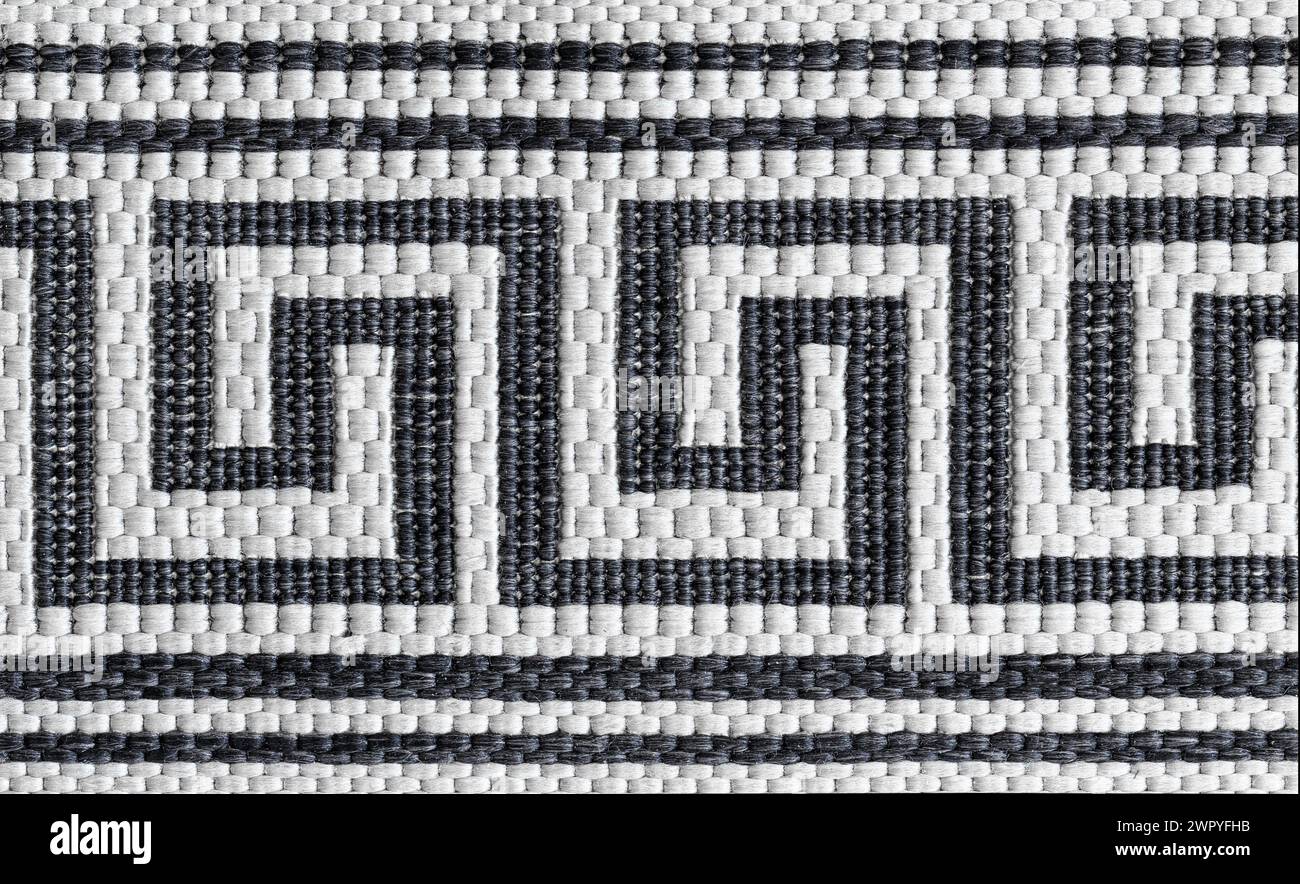 Abstraktes Muster eines gewebten Teppichs. Geometrisches Muster. Makrofotografie. Stockfoto