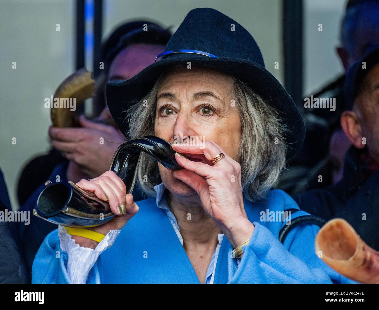 London, Großbritannien. März 2024. Maureen Lipman bläst ihr Horn – Juden und Sympathisanten blasen in einer Synagoge in der Nähe der Abbey Road, London, Shofars (Widderhörner von spiritueller Bedeutung) und pfeifen. Sie zeigen Solidarität mit den mehr als 100 Geiseln, die noch immer in Gaza festgehalten werden, und wollen die Welt für die Bedingungen, denen sie ausgesetzt sind, wecken. Der „Schlag“ wird 1,55 Minuten dauern, was die 155 Tage anbelangt, in denen sie in Gefangenschaft waren. Die Veranstaltung ist Teil der globalen Initiative „Blow for Geiseln“, die von Marcel Knobil organisiert wird. Guy Bell/Alamy Live News Stockfoto