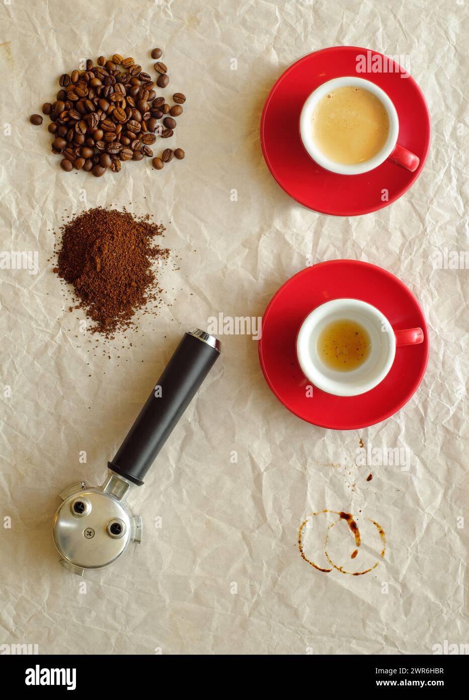 Tasse frisch gebrühten Espresso mit Portafilter, Kaffeebohnen und gemahlenem Kaffee, flach liegend, kostenloser Kopierraum Stockfoto