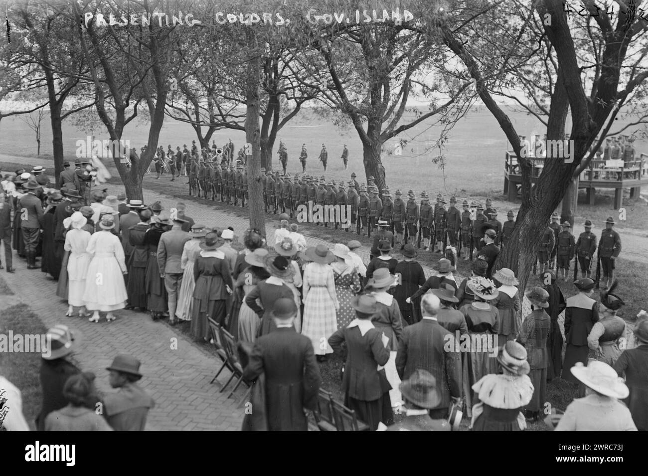 Das Foto zeigt Menschen, die Militärpersonal und eine amerikanische Flagge auf Governors Island, New York, zwischen ca. 1915 und ca. 1920, Regierung ISL, Glas-negative, 1 negativ: Glas Stockfoto