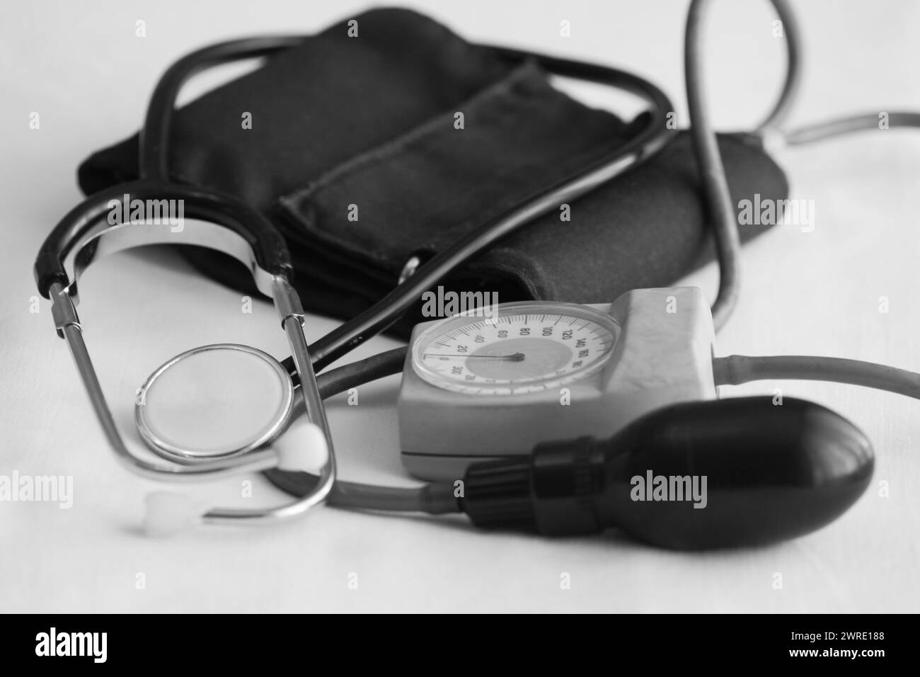 Medizinisches Stethoskop auf weißem Hintergrund. Gesundheitskonzept, Schwarzweißbild. Medizinische Geräte. Stockfoto
