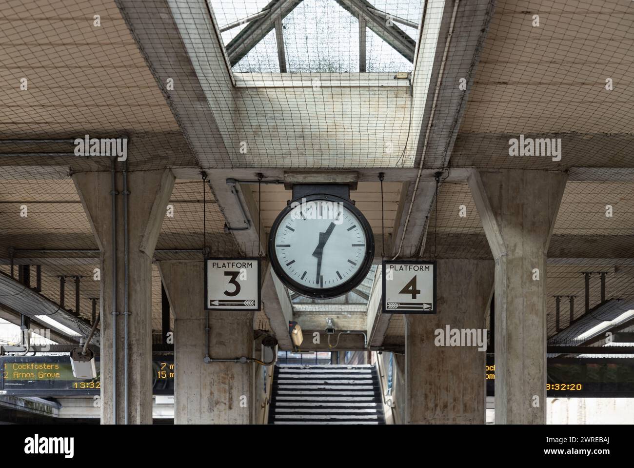 London, Großbritannien - 27. Februar 2024 - 13:31 Uhr auf der Bahnhofsuhr und Bahnsteig Nr. 3 und 4 am Bahnhof Acton Town. Transport, Sp Stockfoto