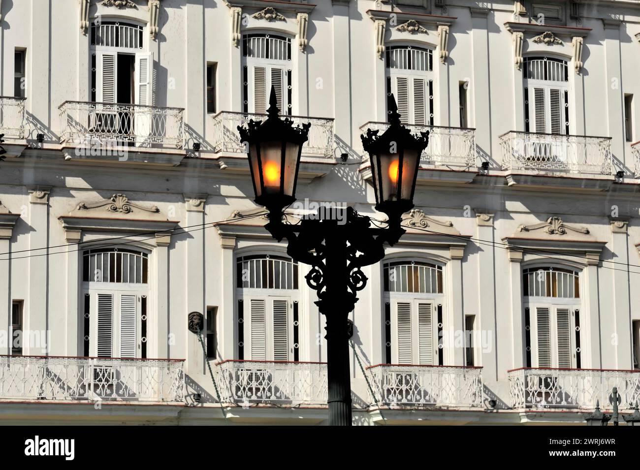 Klassische Architektur mit strukturierten Fensterfassaden und beleuchteten Straßenlaternen, Havanna, Kuba, Zentralamerika Stockfoto