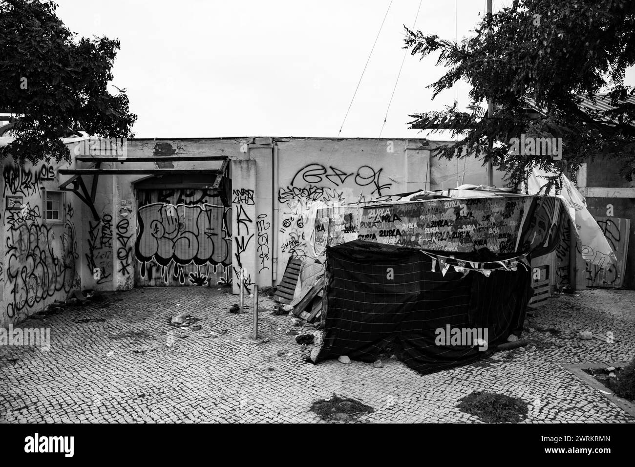 Lissabons urbaner Verfall: Wandbilder im Müll erzählen Geschichten von Widerstandsfähigkeit und Hoffnung in Not Stockfoto
