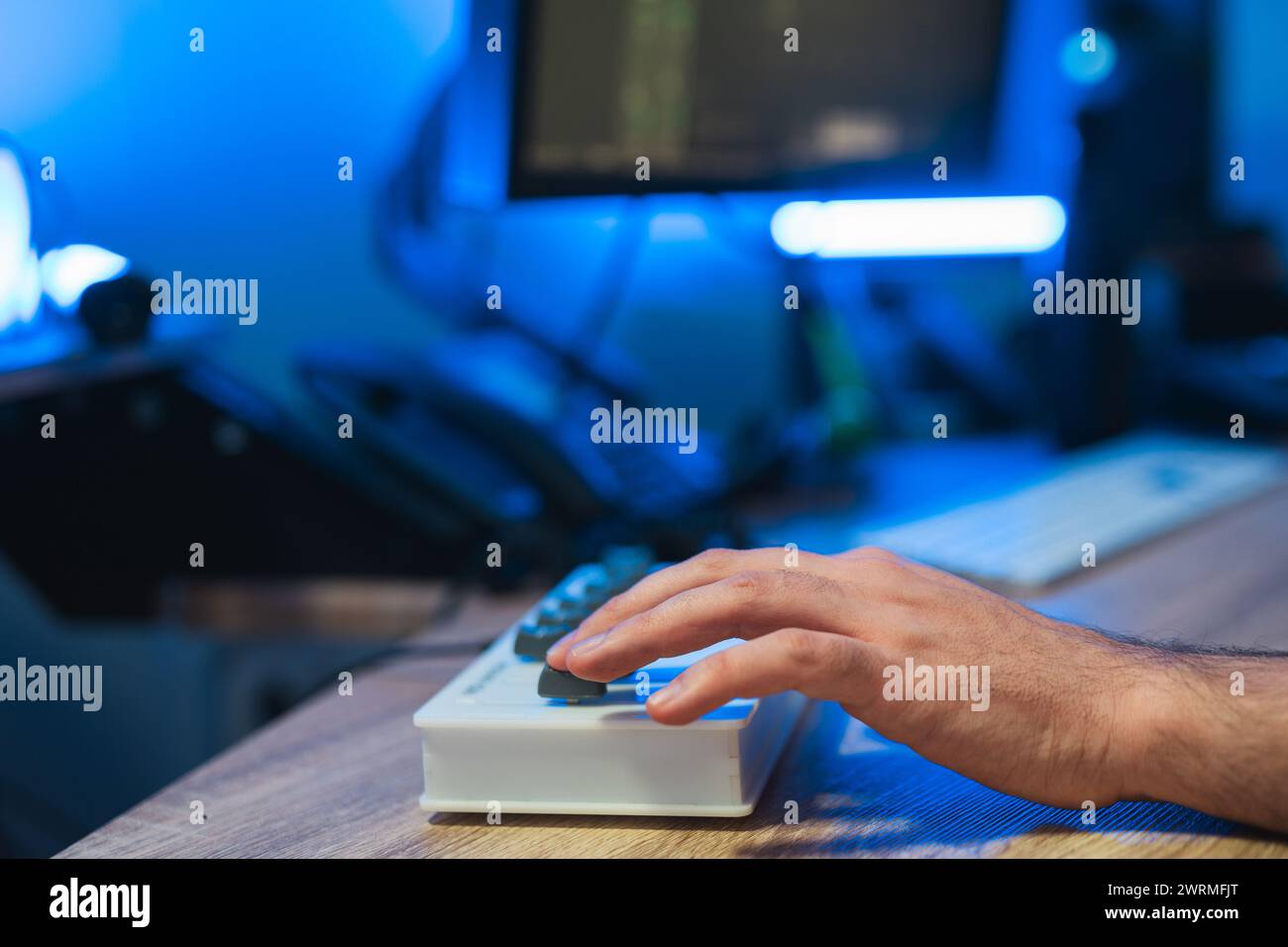 Zugeschnittene, nicht erkennbare Tontechniker-Hand zur Feinabstimmung von Audiogeräten während einer Studioaufnahmesitzung. Stockfoto