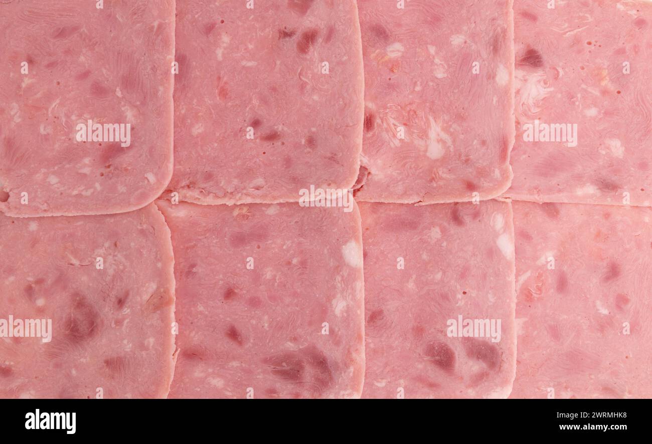 Scheiben Schweineschinken als Hintergrund, Nahaufnahme, Draufsicht Stockfoto