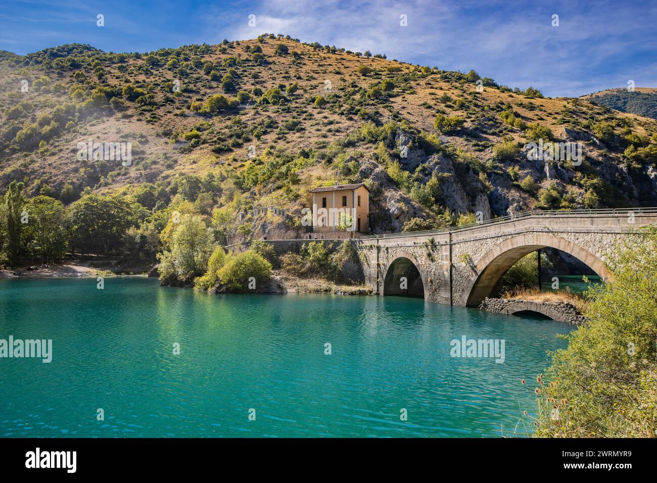 Lake San Domenico, in den Schluchten von Sagittario, in den Abruzzen, L'Aquila, Italien. Die kleine Eremitage mit der Steinbrücke. Die türkisfarbene Farbe des Wassers. Stockfoto