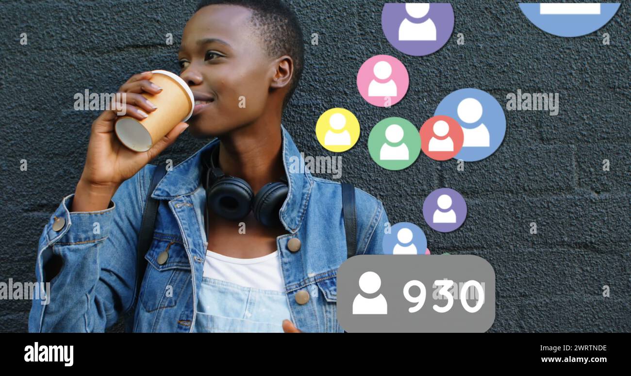 Nahaufnahme eines geparkten Fahrrads ist neben einer schwarzen Frau, die sich auf eine Ziegelwand stützt und Kaffee trinkt Stockfoto