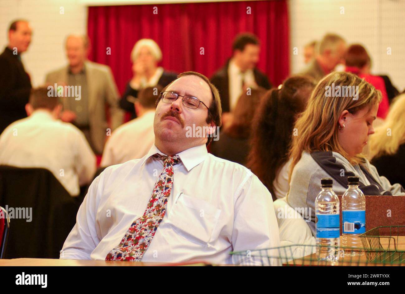 Walisische Parlamentswahlen, Mai 2003. Die Grafen im Vale of Glamorgan sind in der Barry Memorial Hall unterwegs. Die lange Nacht kostet einen Tribut an einem der Theken, während er nickt. Stockfoto