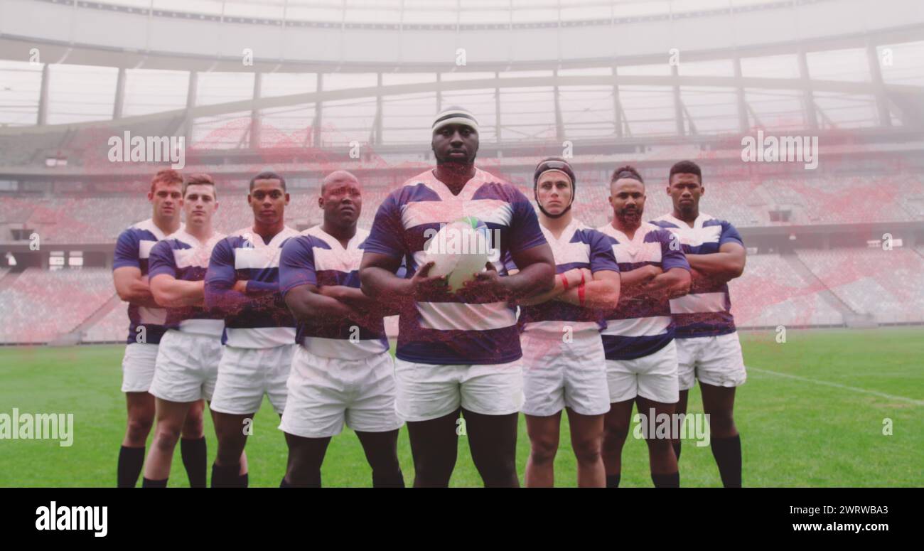 Bild von männlichen Rugbyspielern, die im Stadion Ball halten Stockfoto