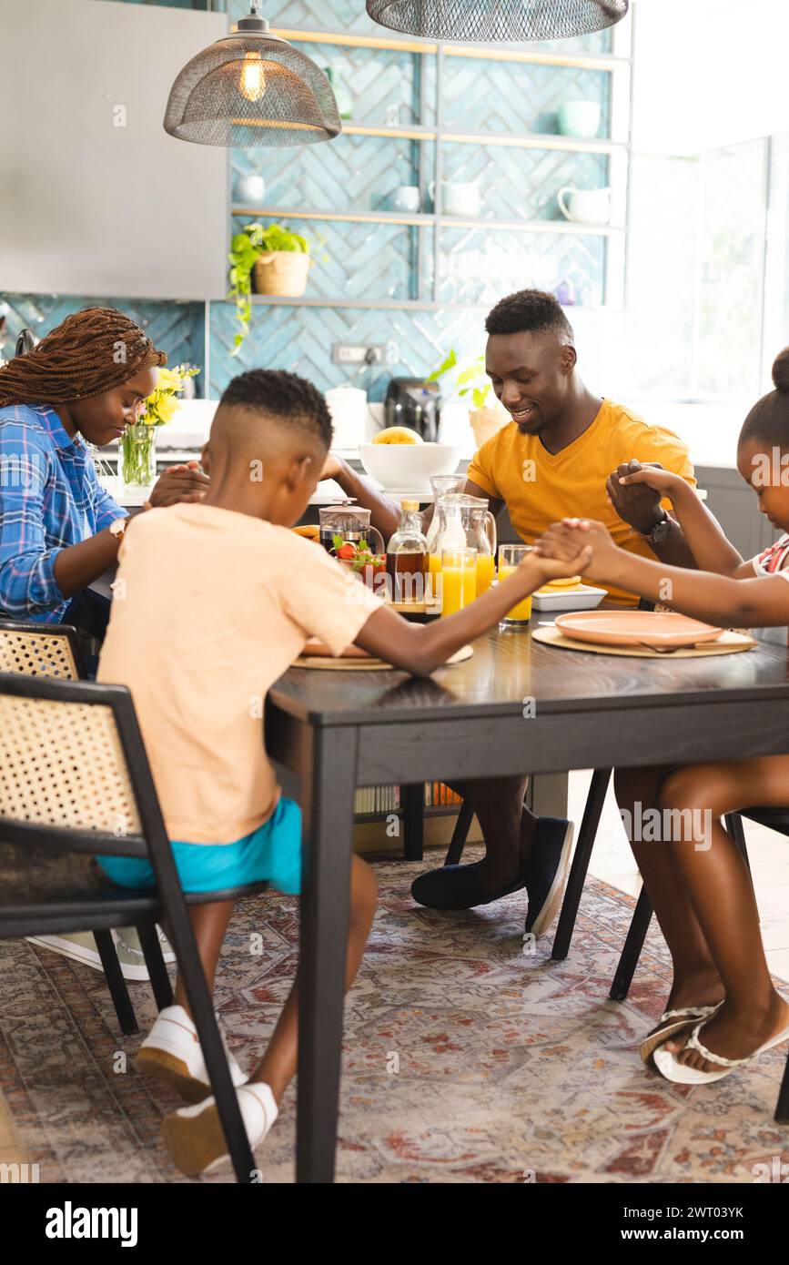 Eine afroamerikanische Familie sagt Gnade und betet vor dem gemeinsamen Frühstück zu Hause Stockfoto