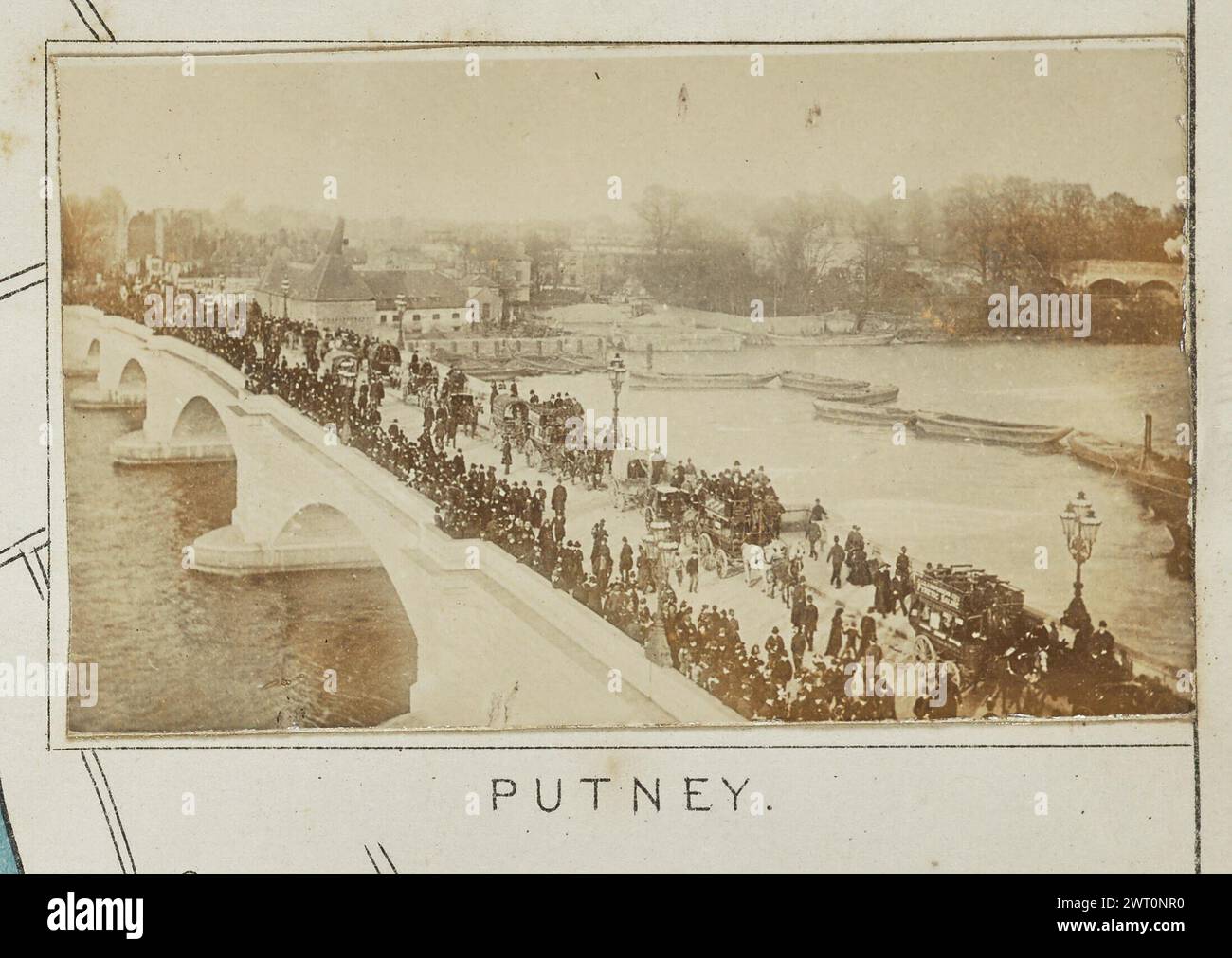 Putney. Henry W. Taunt, Fotograf (Britisch, 1842 - 1922) 1897 eines von vier Fotos mit Tippkarten, die eine gedruckte Karte von Kew, Chiswick, Putney, Fulham und der Umgebung entlang der Themse zeigen. Das Foto zeigt einen erhöhten Blick auf die neu gebaute Putney Bridge. Große Menschenmassen bedecken die Brückenüberspannung, zusammen mit verschiedenen Pferdewagen und Kutschen. Mehrere aufgereihte Lastkähne bilden eine Barriere vor der Brücke im Wasser darunter. (Recto, Mount) unten in der Mitte, unter dem Bild, in schwarzer Tinte gedruckt: 'PUTNEY'. Stockfoto