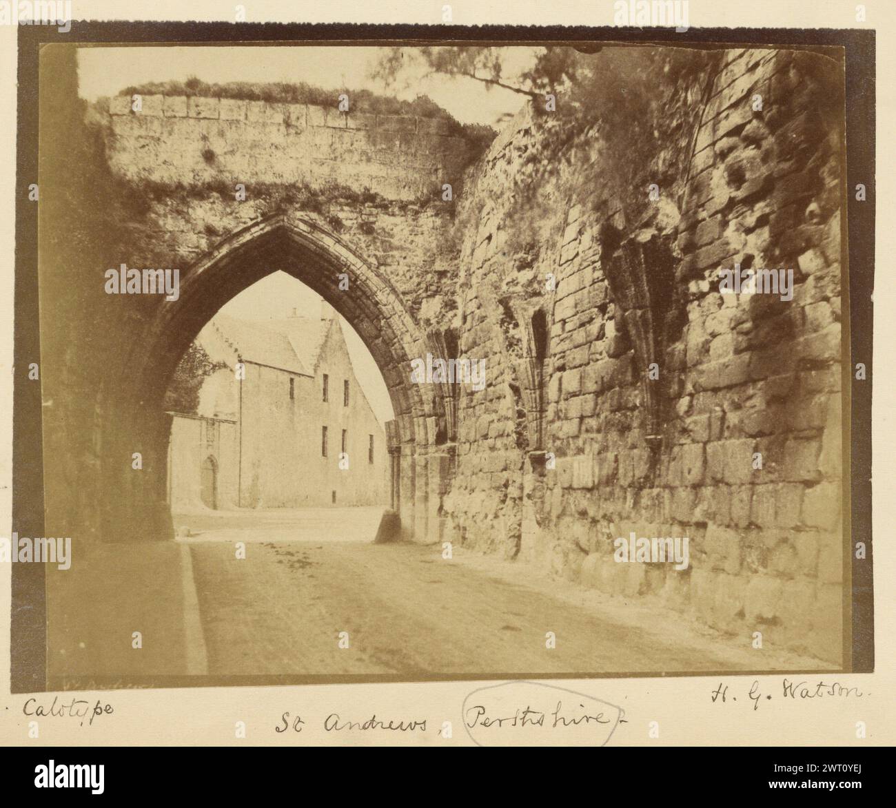 St. Andrews, Perthshire. H. G. Watson, Fotograf (schottisch, aktive 1850er Jahre) 1854–1856 ein Bogengang über einer Straße in St. Andrews, mit einer Steinmauer, die rechts verläuft. Gras wächst über dem oberen Teil des Bogens. (Recto, Mount) unten rechts, unten Bild, in schwarzer Tinte: 'Calotype'; unten in der Mitte, unten in schwarzer Tinte: 'St Andrews, Perthshire - / File' ['File' geschrieben mit Bleistift und unterstrichen, 'Perthshire' eingekreist im Bleistift]; unten rechts, unten in schwarzer Tinte: 'H.G. Watson'; (Verso, Mount) unten links, Bleistift: 'A15.30'; Stockfoto