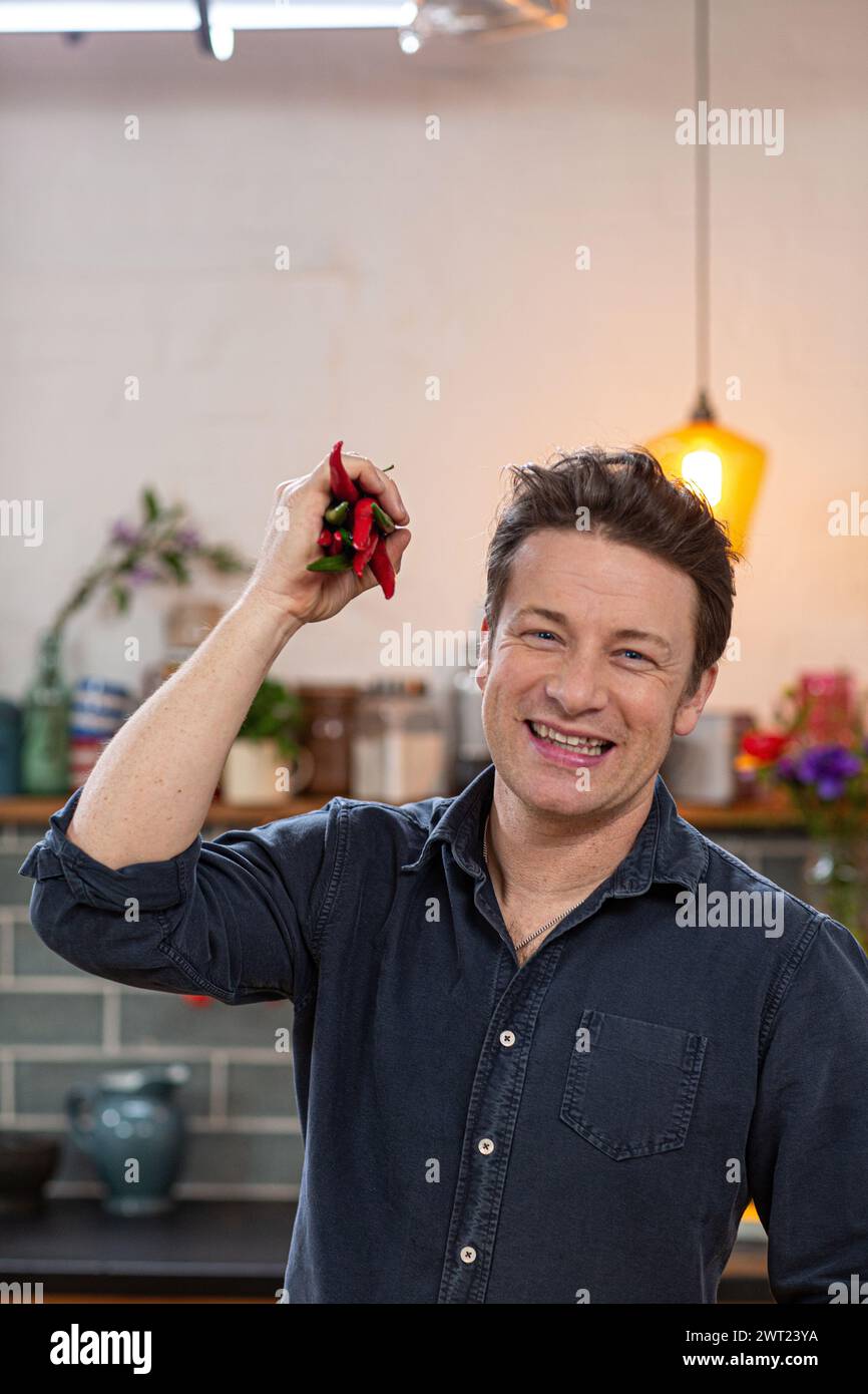 Jamie Oliver, englischer Starkkoch, Restauranteur mit einem Haufen Chili-pfeffer Stockfoto