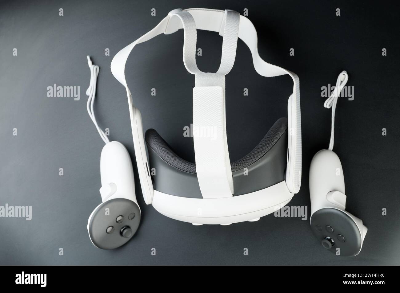 VR-Headset mit Controllern über Draufsicht, isoliert auf Studiohintergrund Stockfoto