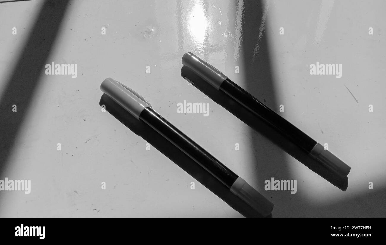 Foto eines Asiaten, der einen Marker vor einem Papierhintergrund hält Stockfoto