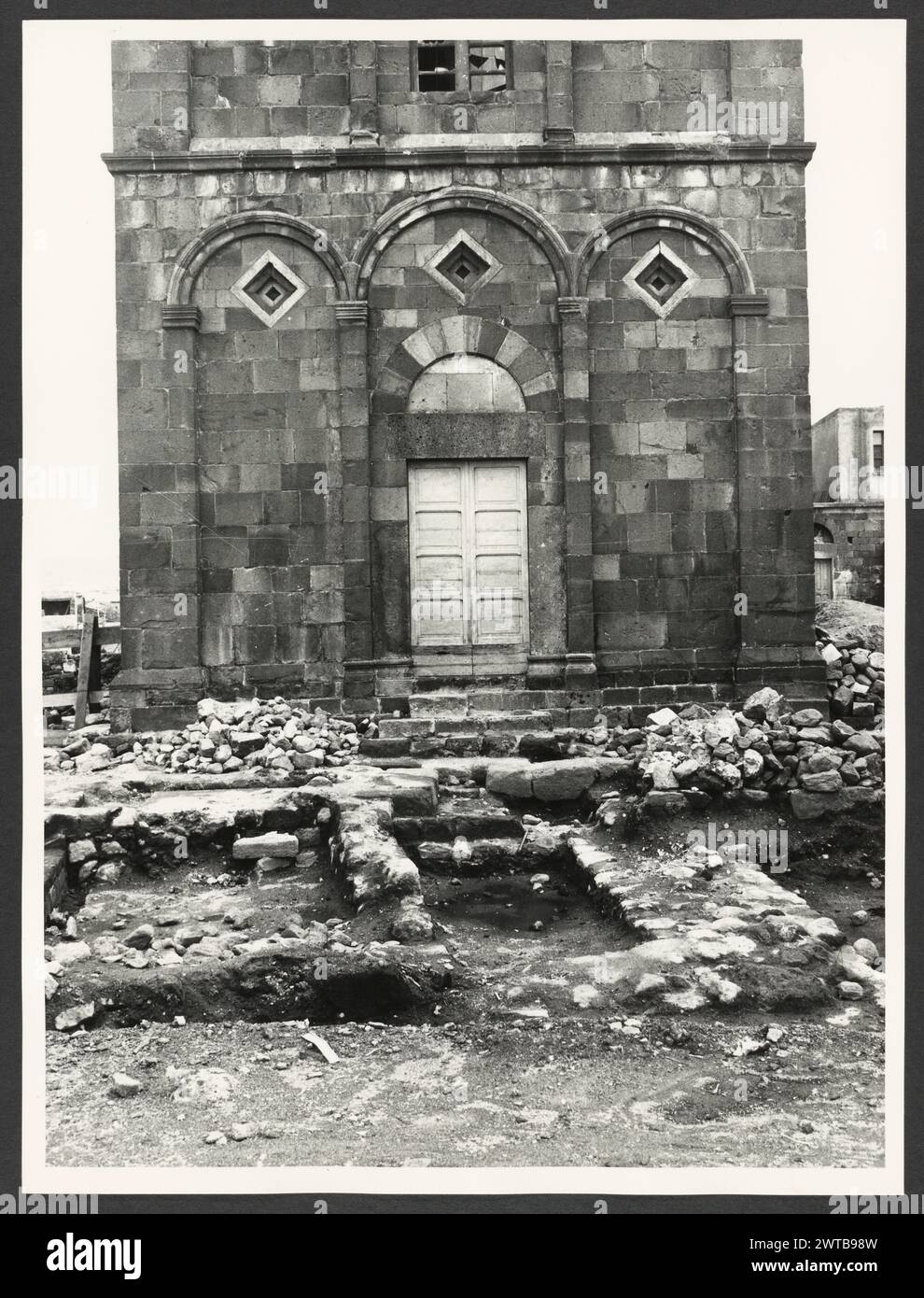 Sardinia Nuoro Ottana S. Nicola. Hutzel, Max. 1960-1990 Mittelalter: Romanische Architektur (12. Jahrhundert) in schwarz-violettem Trachyt; verzierte Fassade mit eingeschnittenen Lutangen, Pilastern und Maiolica in kleinen Vertiefungen. Etwas pisanischer Einfluss. Altertümer: Nuragische Gräber der in Deutschland geborene Fotograf und Gelehrte Max Hutzel (1911–1988) fotografierte in Italien von den frühen 1960er Jahren bis zu seinem Tod. Das Ergebnis dieses Projektes, von Hutzel als Foto Arte Minore bezeichnet, ist eine gründliche Dokumentation der kunsthistorischen Entwicklung in Italien bis zum 18. Jahrhundert, einschließlich der Objekte der Etrusker und Th Stockfoto