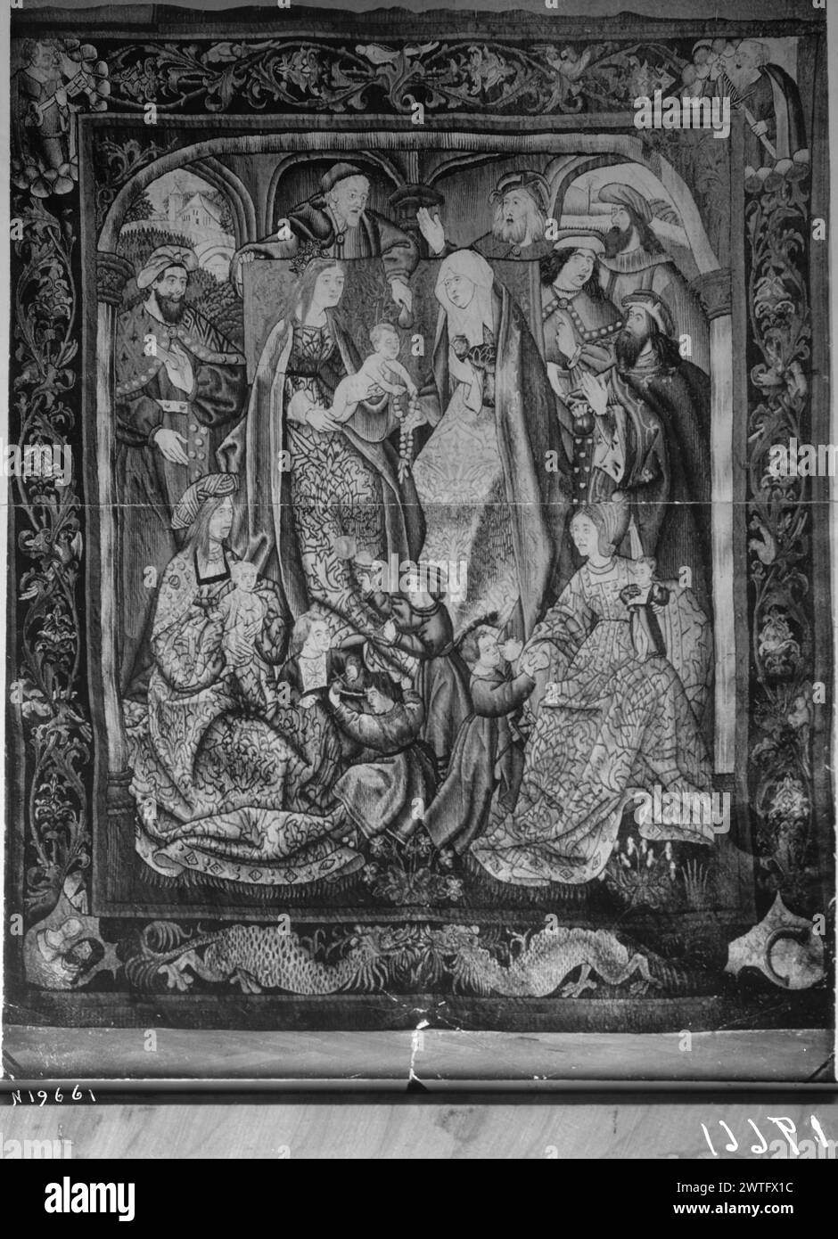 Geburt Christi: Heilige Familie Trinitas terrestris. Unbekannt ca. 1510-1530 Gobelin Materialien/Techniken: Unbekannt Kultur: Southern Netherlands Weaving Center: Unbekannt Besitz Geschichte: Französisch & Co. Auf dem Thron sitzt Christkind auf dem Schoß der Jungfrau Maria und streckt nach dem Rosenkranz, den ihm von der Heiligen überreicht wurde Anne; St. Joseph übergibt die Birne von oben; umgeben von männlichen Figuren, Frauen und Kindern (L, UPR & R BRD), die sich mit Laubstöcken und kleinen Vögeln verflechten; (UPR BRD) Heilige in den Ecken: St. Peter hält Schlüssel (L) und St. Paul (?) Schwert halten (R); (LWR BRD) 2 Drachen von Angesicht zu Angesicht; Wappen Stockfoto