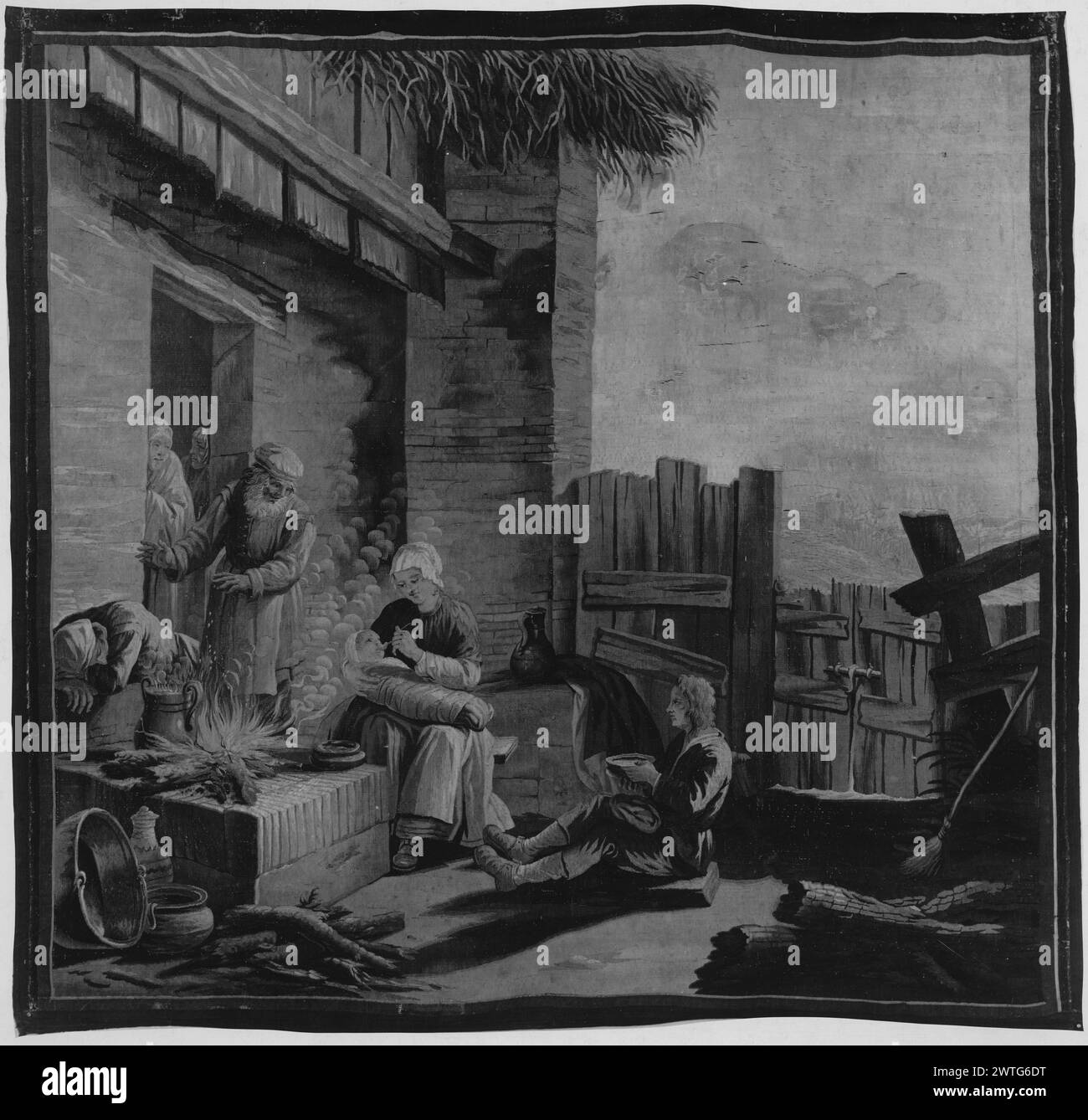 Heimische Szene. Unbekannt ca. 1700-1775 Gobelin Materialien/Techniken: Unbekannt Kultur: Flämisches Weberzentrum: Unbekannt vor dem Haus, Familie sitzt draußen beim Feuer; Frau füttert Baby; junger Mann auf dem Boden isst von der Schüssel; alter Mann wärmt die Hände durch Feuer, während eine andere Figur durch Feuergrenzen zusammengebrochen ist. Stockfoto