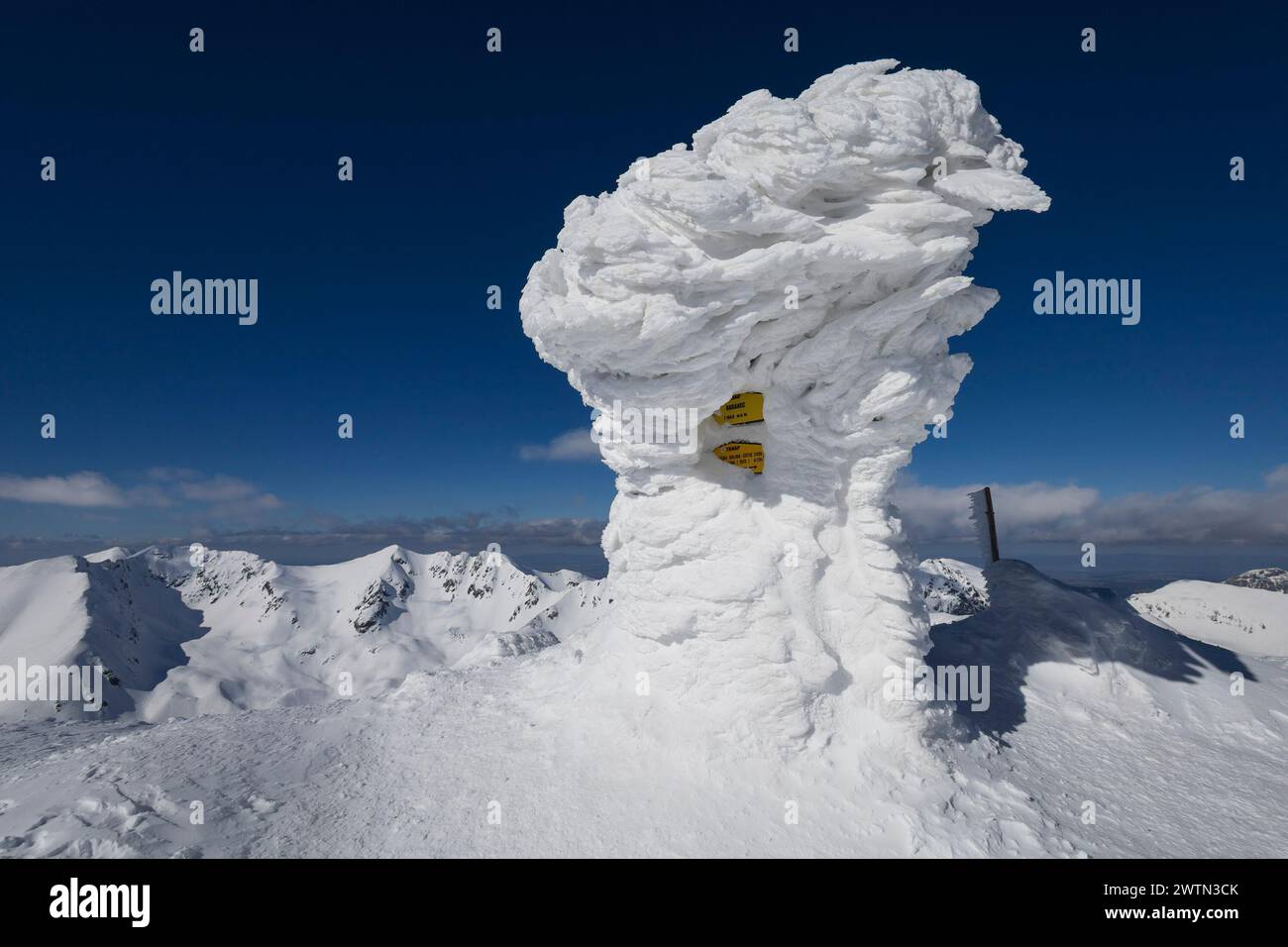 Baranec, Westtatra, Slowakei. Steinobelisk auf dem Gipfel des Berges ist im Winter von Schnee und Eis bedeckt. Winterlandschaft mit sonnigem Wetter Stockfoto