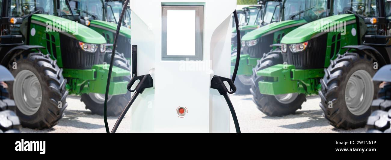 Ladestation für Elektrofahrzeuge vor dem Hintergrund landwirtschaftlicher Traktoren. Konzept Stockfoto