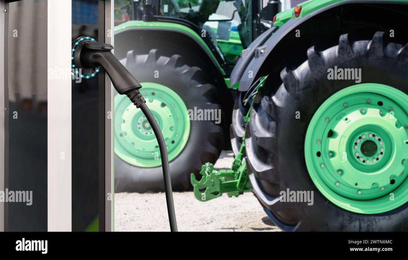 Ladestation für Elektrofahrzeuge vor dem Hintergrund landwirtschaftlicher Traktoren. Konzept Stockfoto