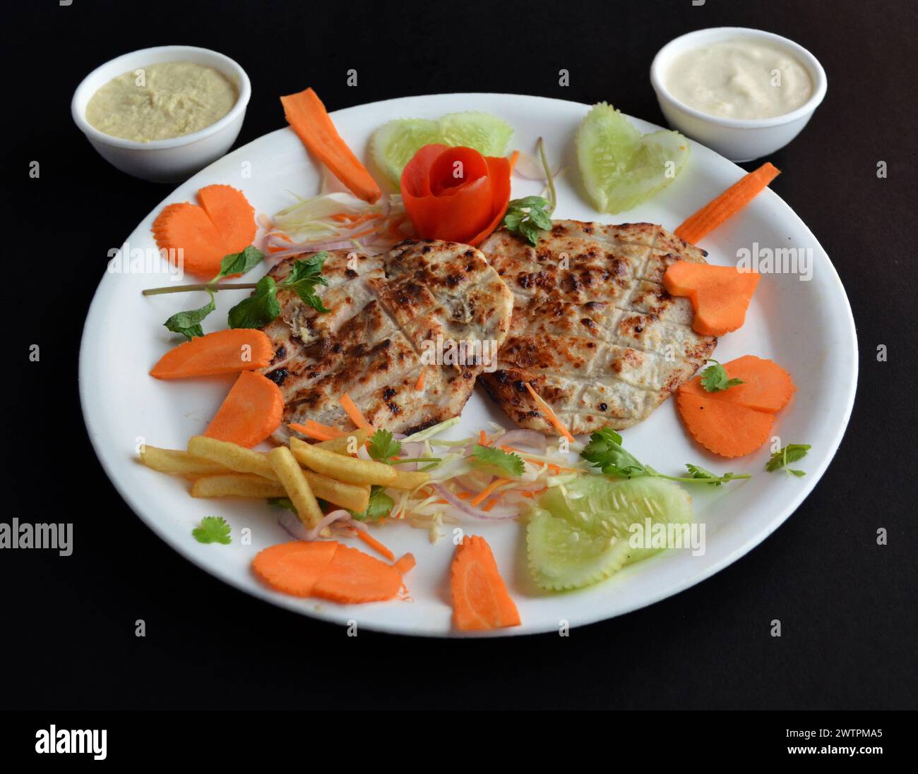 Arabisches Huhn ist ein aromatisches Gericht, das tief im kulinarischen Erbe des Nahen Ostens verwurzelt ist und mit Karotten-Zitrone und Mayo garniert wird Stockfoto