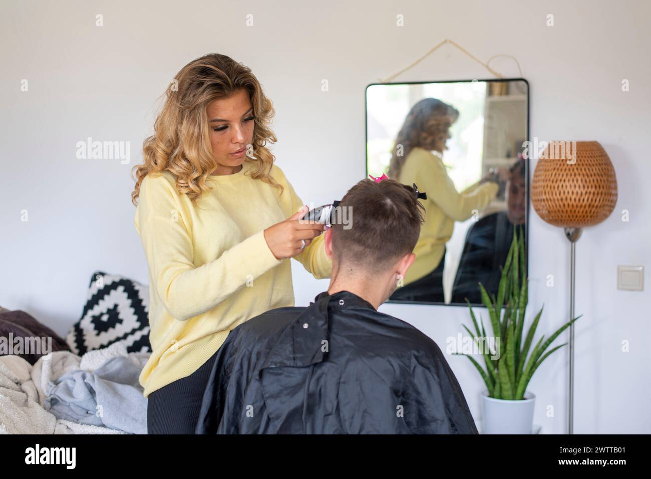 Haarschnitt zu Hause mit Sorgfalt und Fokus Stockfoto