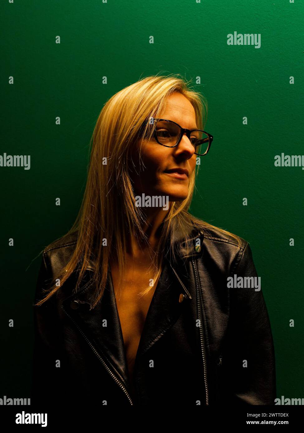 Besinnliche Frau vor grünem Hintergrund Stockfoto