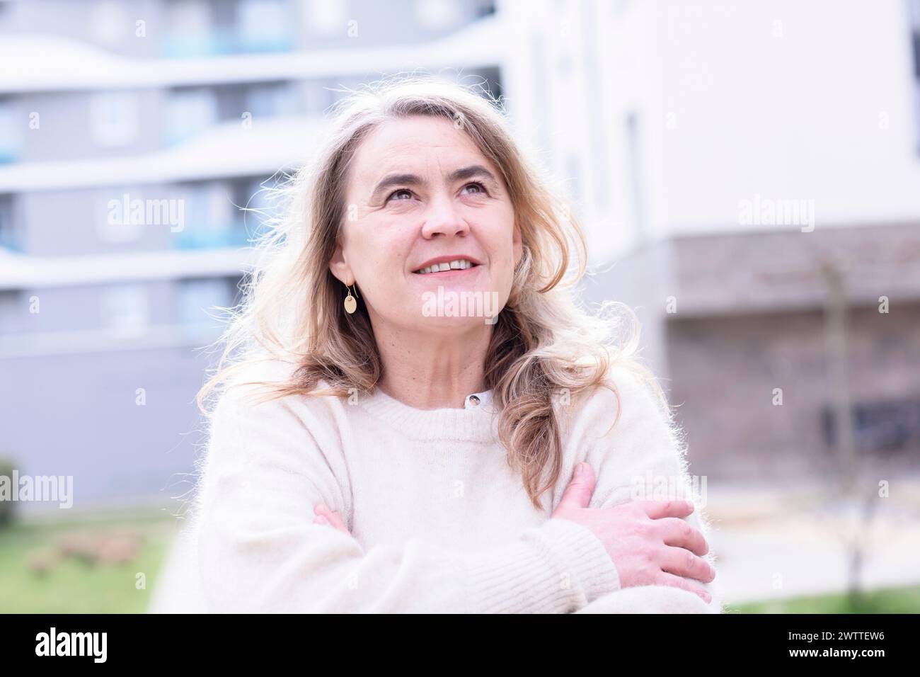 Eine lächelnde Frau, die einen Moment im Freien genießt Stockfoto