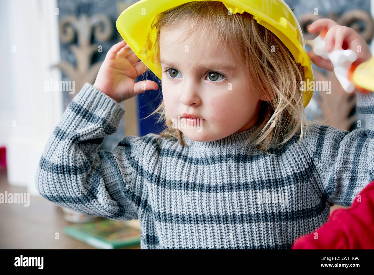 Kind in einem gelben Schutzhelm Stockfoto