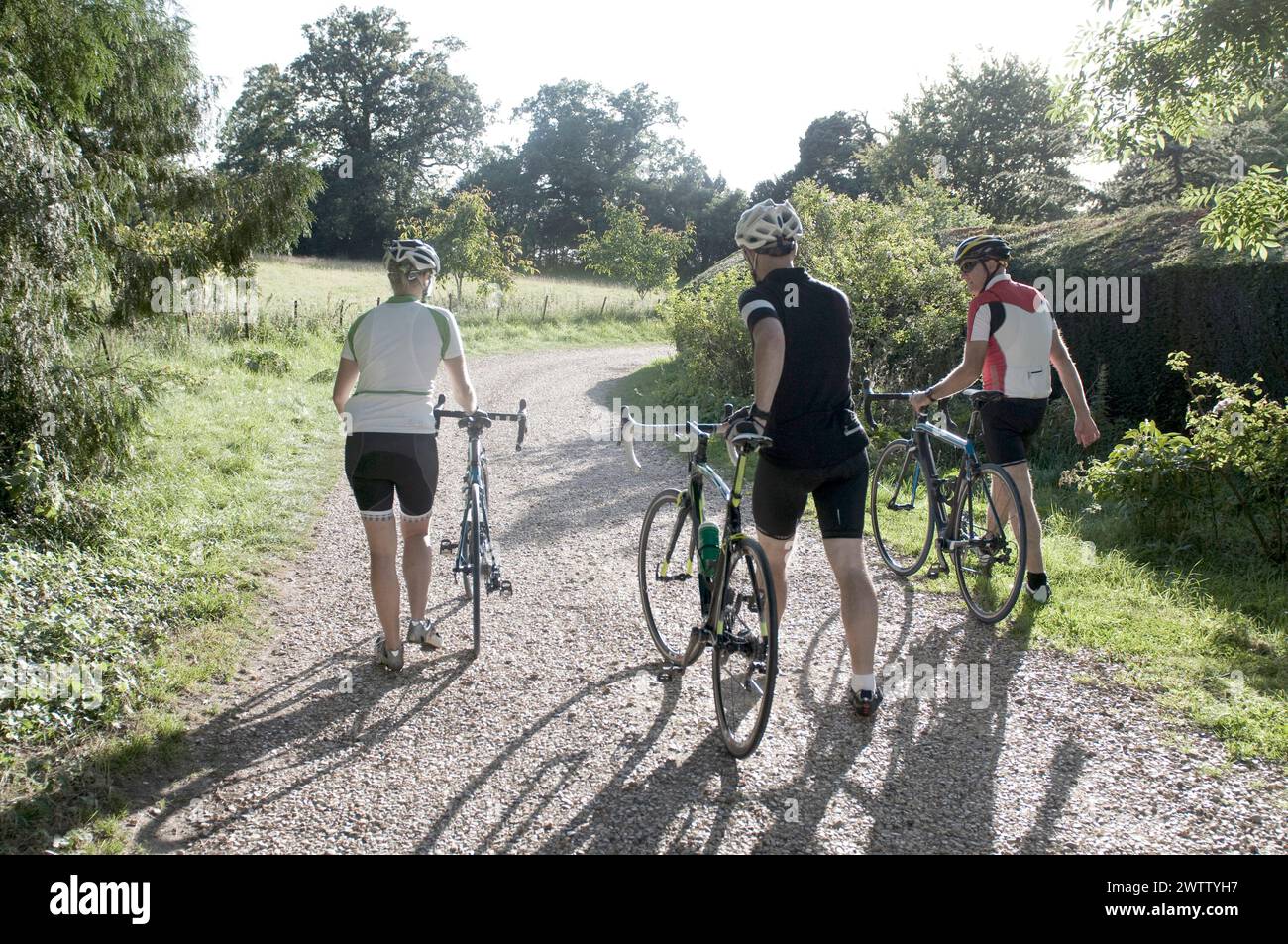 Radfahrer stehen mit Fahrrädern auf einem unbefestigten Weg. Stockfoto